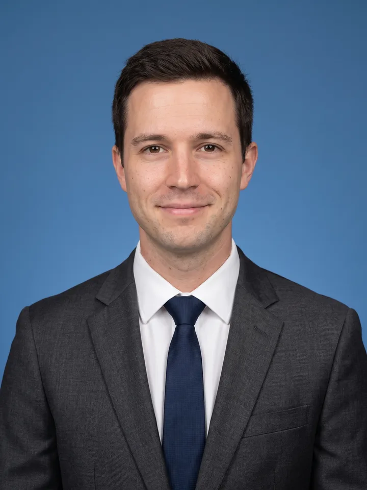 ID photo of a man on a blue background in business attire